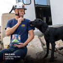 Person in a blue shirt and helmet with a black dog, holding Nulo dog food packaging, with 'Arizona Search Dogs Team' branding.